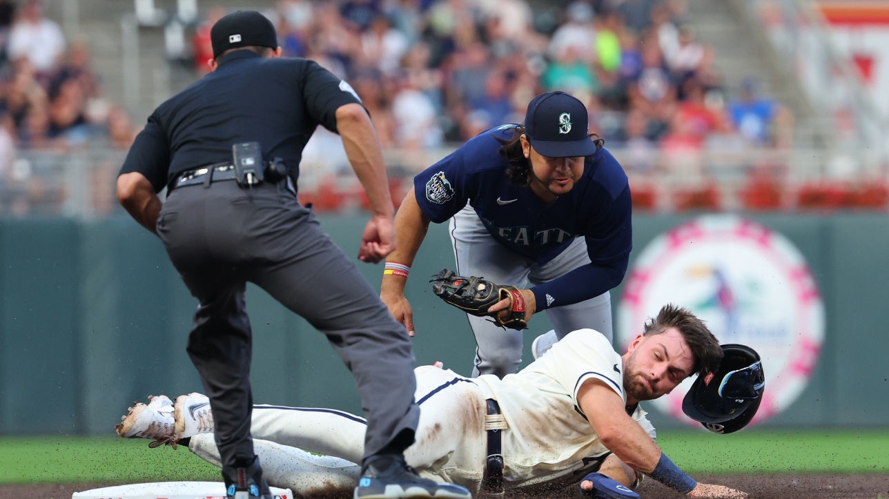 MLB: Edward Julien is hit in the right shoulder after being thrown out from third base